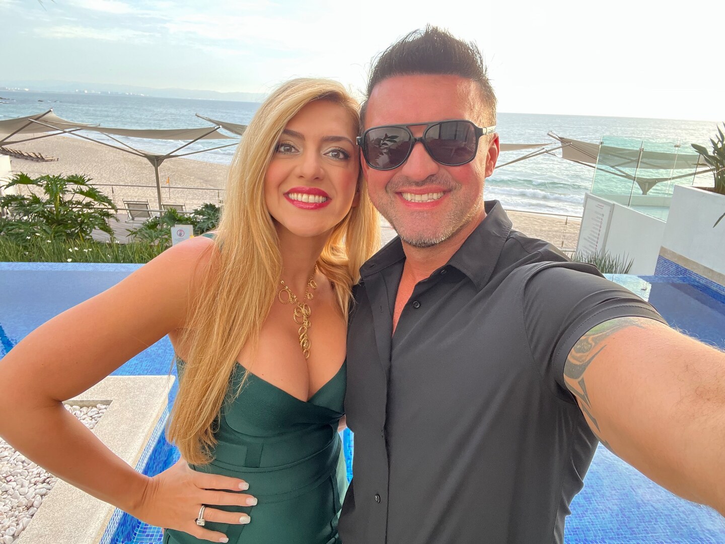 Sarah and Jeremy McQuinn overlooking the beach at a resort.